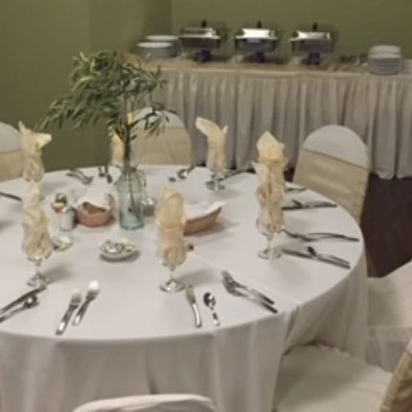 A round table set for dining with a buffet line in the background at JP's Family Restaurant.